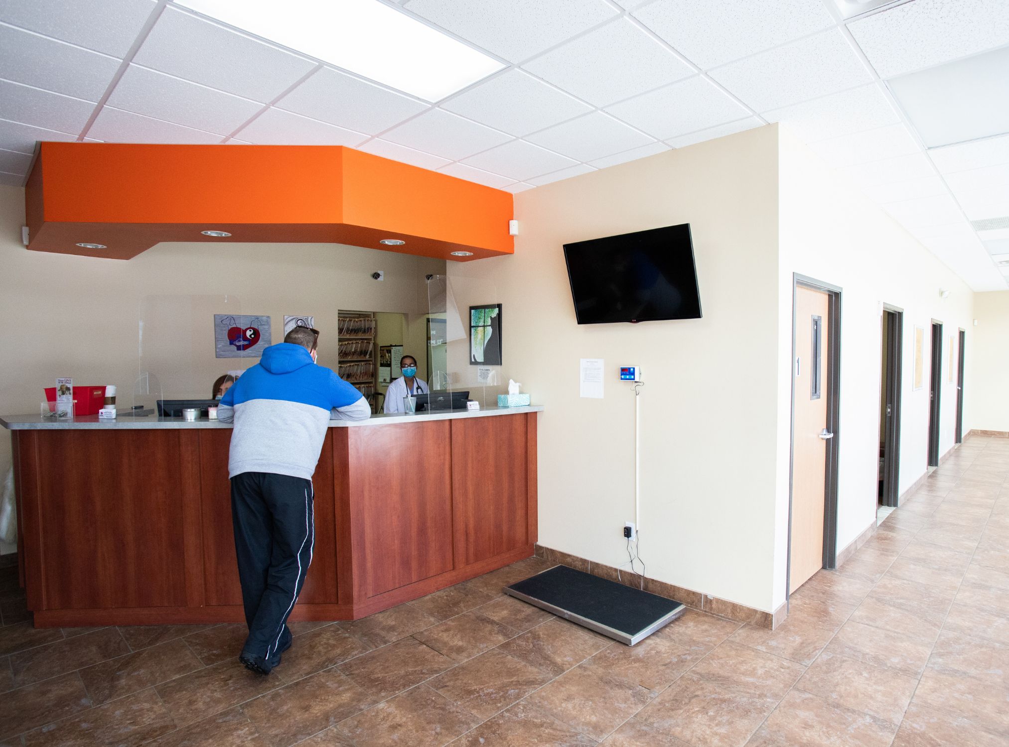 A man is standing at hospital reception